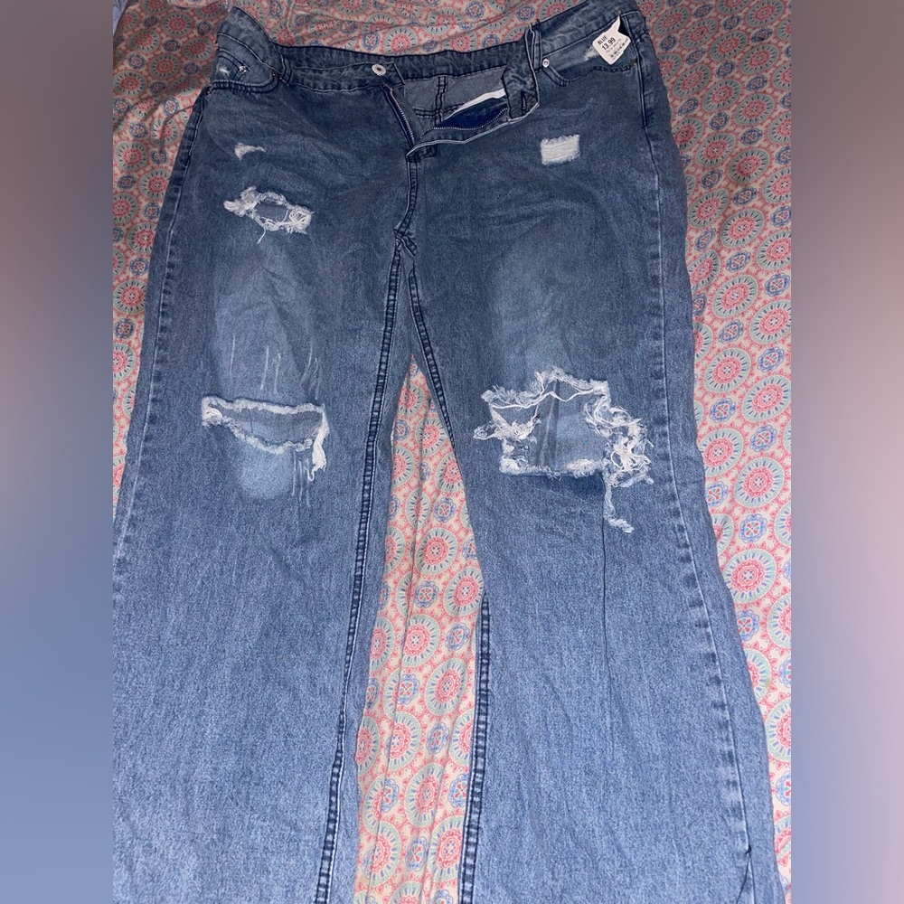 Straight leg Blue jeans with rips in the knees.